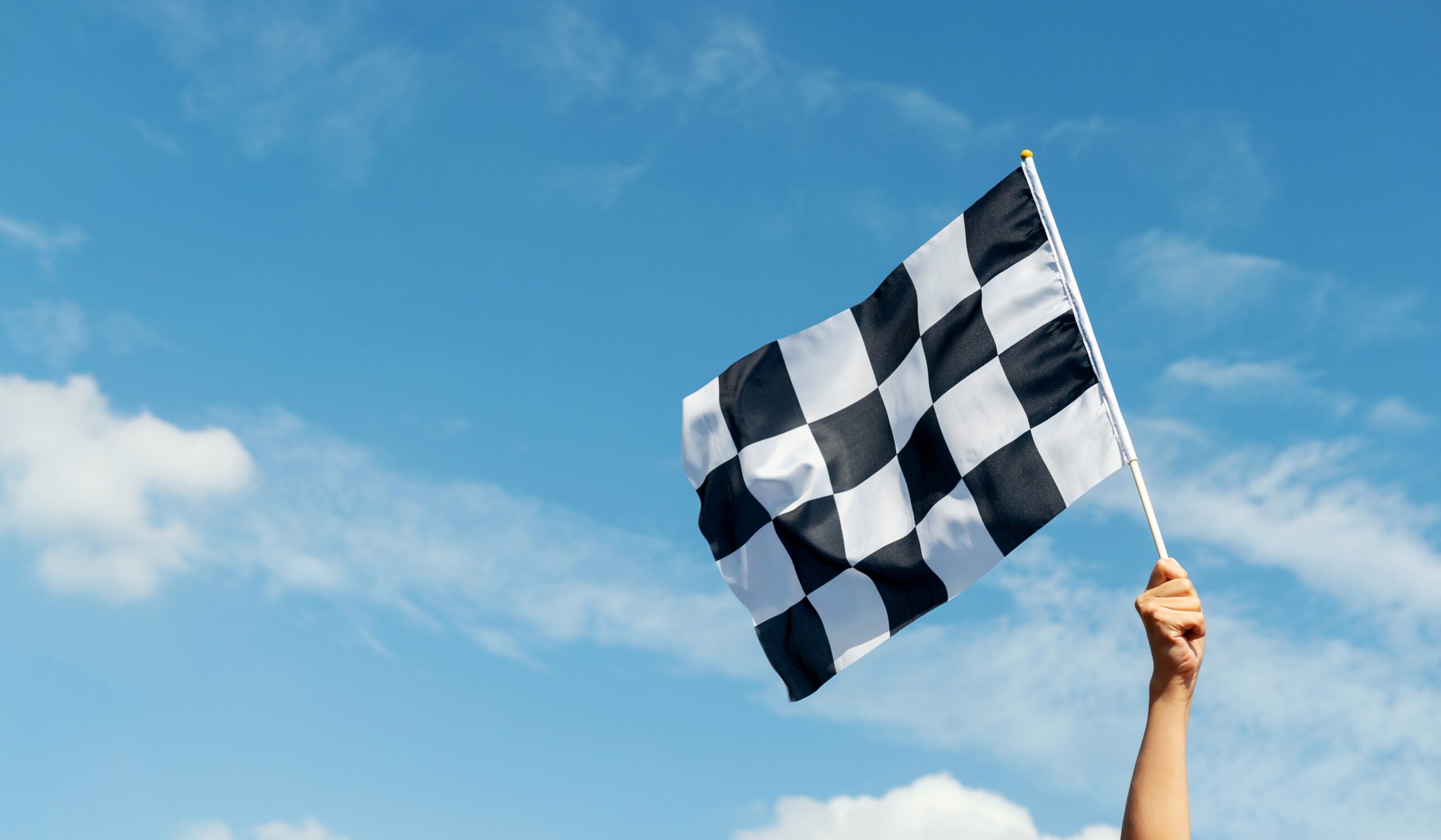 An image of a flag waving at the start of a Formula 1 race