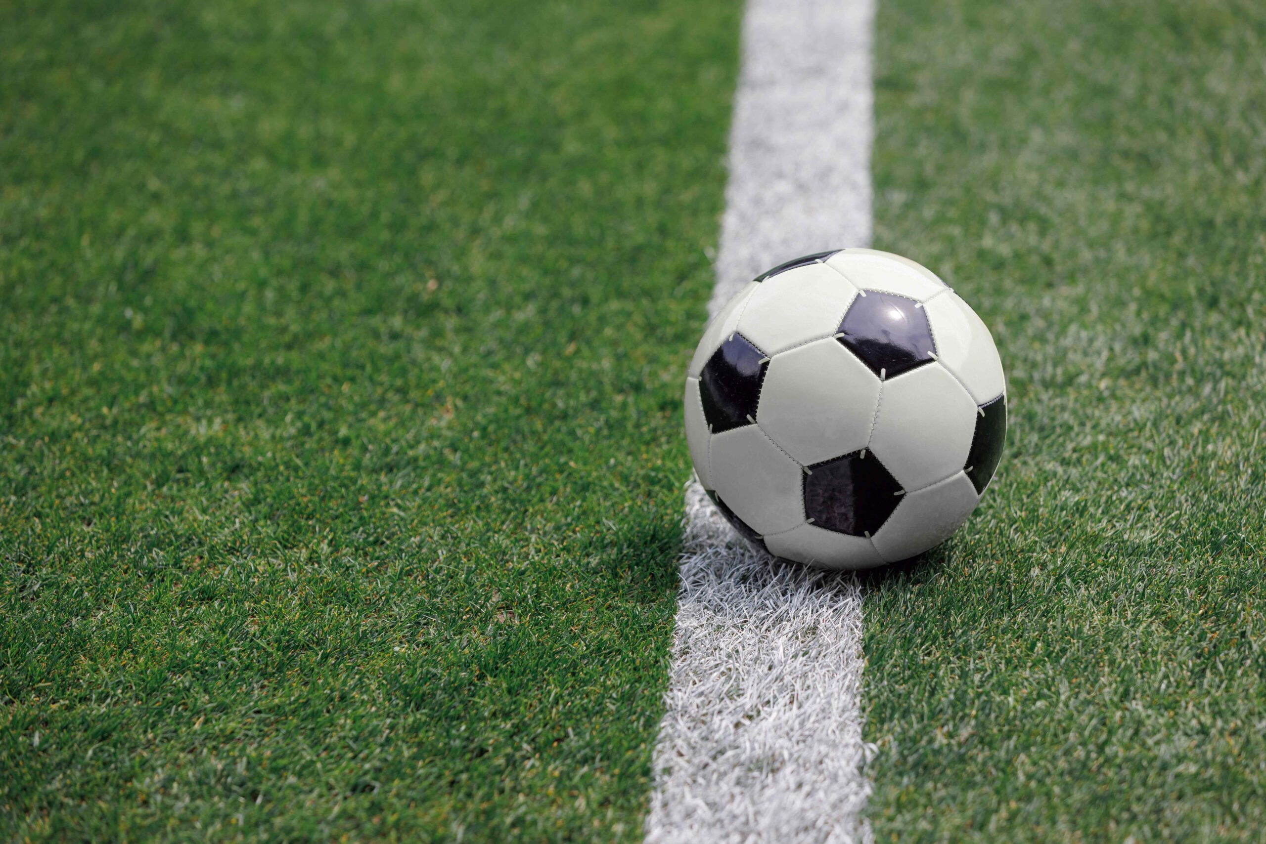 A ball in the middle of a soccer field
